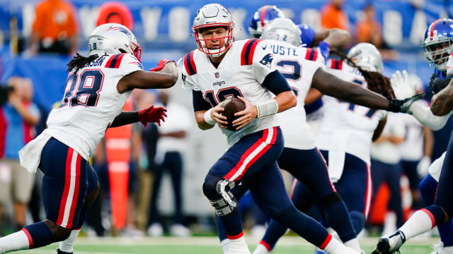New England Patriots QB Mac Jones drops back to attempt a preseason pass against the New York Giants
